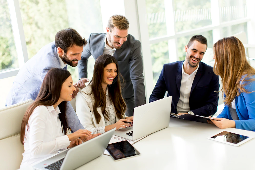startup-business-team-meeting-modern-bright-office-interior-working-laptop_52137-1199